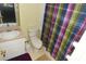Bathroom with light pink vanity, toilet, and colorful shower curtain at 4754 Sabal Key Dr, Bradenton, FL 34203