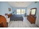 Spacious bedroom with plank flooring, natural light, and wood furnishings at 4754 Sabal Key Dr, Bradenton, FL 34203