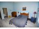 Relaxing bedroom featuring light blue walls and plank flooring at 4754 Sabal Key Dr, Bradenton, FL 34203