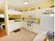 Bright kitchen featuring white cabinets and appliances, and tiled flooring at 4754 Sabal Key Dr, Bradenton, FL 34203