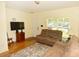 Inviting living room featuring a plush sofa, laminate flooring, and natural light at 4754 Sabal Key Dr, Bradenton, FL 34203