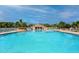 Community pool with a pool house surrounded by palm trees at 4754 Sabal Key Dr, Bradenton, FL 34203