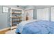 Charming bedroom with blue walls, a bookshelf, and view of an adjacent room at 5014 Marshfield Rd # 30, Sarasota, FL 34235