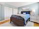 Comfortable bedroom with wooden floors, a large closet, and a calming blue color scheme at 5014 Marshfield Rd # 30, Sarasota, FL 34235