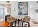 Dining area features modern art piece and adjacent access to hardwood floors at 5014 Marshfield Rd # 30, Sarasota, FL 34235