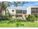 Modern home showcasing lush landscaping and expansive lawn area, creating a serene outdoor space at 5014 Marshfield Rd # 30, Sarasota, FL 34235