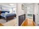 Open hallway view to a bedroom with a queen bed and the main bedroom at 5014 Marshfield Rd # 30, Sarasota, FL 34235