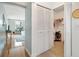 Hallway with wood flooring, access to a closet, and a view of a bright study or bedroom at 5014 Marshfield Rd # 30, Sarasota, FL 34235