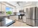 Modern kitchen with stainless steel appliances, granite countertops, and white cabinets for a bright look at 5014 Marshfield Rd # 30, Sarasota, FL 34235