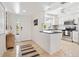 Bright kitchen with white cabinets, stainless steel appliances, and adjacent entryway at 5014 Marshfield Rd # 30, Sarasota, FL 34235