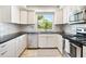 Clean, white kitchen with stainless steel appliances and subway tile backsplash at 5014 Marshfield Rd # 30, Sarasota, FL 34235