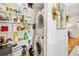 Well-organized laundry room with stacked washer/dryer and ample shelving for storage at 5014 Marshfield Rd # 30, Sarasota, FL 34235