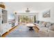 Bright living room with coastal decor, hardwood floors, and water view through the sliding glass doors at 5014 Marshfield Rd # 30, Sarasota, FL 34235