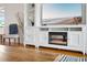 Living room with white entertainment center, fireplace, and beach themed decorations at 5014 Marshfield Rd # 30, Sarasota, FL 34235