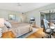 Bright main bedroom featuring wooden floors, a walkout slider to a patio, and a ceiling fan at 5014 Marshfield Rd # 30, Sarasota, FL 34235