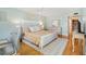 Serene main bedroom featuring a neutral color scheme, wooden floors, and a decorative rug at 5014 Marshfield Rd # 30, Sarasota, FL 34235