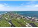 A coastal aerial view of the neighborhood, with the ocean, golf course, and luxury homes at 524 Schooner Ln, Longboat Key, FL 34228