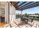 Relaxing covered terrace with an outdoor dining table, offering scenic waterfront views and a pergola at 524 Schooner Ln, Longboat Key, FL 34228