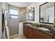 Bathroom with dual sink granite vanity and walk-in glass shower at 524 Schooner Ln, Longboat Key, FL 34228