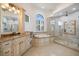 Beautiful bathroom features a walk-in shower and a separate soaking tub under a bright window at 524 Schooner Ln, Longboat Key, FL 34228