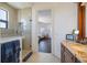 Bathroom features a glass-enclosed shower, granite vanity, and a glimpse into an adjacent living space at 524 Schooner Ln, Longboat Key, FL 34228