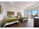 Light-filled bedroom with twin beds, tray ceilings, and access to an outdoor balcony with seating at 524 Schooner Ln, Longboat Key, FL 34228