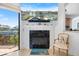 Cozy fireplace with mantel, tile surround, and access to the outdoor patio with canal view at 524 Schooner Ln, Longboat Key, FL 34228