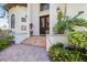 Stunning facade featuring a tiled walkway, lush landscaping, and a grand front entrance with double doors at 524 Schooner Ln, Longboat Key, FL 34228