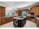 Spacious kitchen boasts custom wood cabinetry, granite counters and black kitchen island at 524 Schooner Ln, Longboat Key, FL 34228