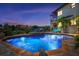 Luxurious outdoor pool and spa area with lush tropical landscaping and a view of the home's exterior at 524 Schooner Ln, Longboat Key, FL 34228