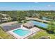 Aerial view of the community pool, tennis courts, and surrounding lush landscaping at 5642 29Th Street E Cir, Bradenton, FL 34203