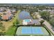 A beautiful aerial view highlighting the community pool, lake, and tennis court at 5642 29Th Street E Cir, Bradenton, FL 34203