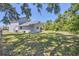 Peaceful backyard featuring a large, well-manicured lawn and plenty of shade from mature trees at 5642 29Th Street E Cir, Bradenton, FL 34203