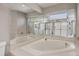 Bathroom featuring large mirrors, a corner tub and separate shower enclosure at 5642 29Th Street E Cir, Bradenton, FL 34203