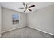 Bedroom featuring carpeting, a ceiling fan, and a large window at 5642 29Th Street E Cir, Bradenton, FL 34203