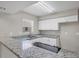 Modern kitchen featuring sleek granite countertops, stainless steel appliances, and white cabinetry at 5642 29Th Street E Cir, Bradenton, FL 34203