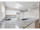 Bright kitchen with granite countertops, stainless steel sink, and ample cabinet space at 5642 29Th Street E Cir, Bradenton, FL 34203