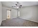 Main bedroom with attached bathroom, carpeting and ceiling fan at 5642 29Th Street E Cir, Bradenton, FL 34203