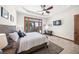 Bright bedroom with tray ceiling, desk and balcony access offering serene views at 5830 Jamila River Dr, Venice, FL 34293