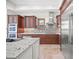 Spacious kitchen featuring custom cabinetry, tile backsplash, and stainless steel appliances at 5830 Jamila River Dr, Venice, FL 34293