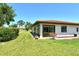 Charming backyard featuring green grass, landscaping and a peaceful outdoor setting at 6007 Vivienda Dr # 29, Bradenton, FL 34207