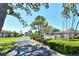 Inviting community entrance with lush landscaping, mature trees and signage at 6007 Vivienda Dr # 29, Bradenton, FL 34207
