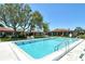 Large community pool featuring ample seating and manicured landscaping at 6007 Vivienda Dr # 29, Bradenton, FL 34207