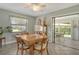Bright dining room features large window and sliding glass door to the lanai at 6007 Vivienda Dr # 29, Bradenton, FL 34207