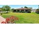 Beautiful landscaping with a flower bed enhances the curb appeal of this home at 6007 Vivienda Dr # 29, Bradenton, FL 34207
