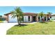 Charming single-story home with a red tile roof, a well-manicured lawn, and lush palm trees at 6007 Vivienda Dr # 29, Bradenton, FL 34207