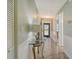 Bright hallway with tile floors and elegant wainscoting leading to various rooms in the home at 6007 Vivienda Dr # 29, Bradenton, FL 34207