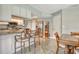 Cozy kitchen with breakfast bar, stainless steel appliances, and tiled floor at 6007 Vivienda Dr # 29, Bradenton, FL 34207