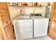 Convenient laundry room featuring a white washer, dryer, and ample storage at 6007 Vivienda Dr # 29, Bradenton, FL 34207