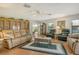 Open living room with hardwood floors, comfortable seating, and a vintage china cabinet at 6007 Vivienda Dr # 29, Bradenton, FL 34207